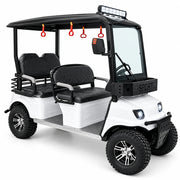 A white and black four-seater golf cart with a roof canopy, front headlight, and a blue LED light bar on top, displayed indoors against a green wall.